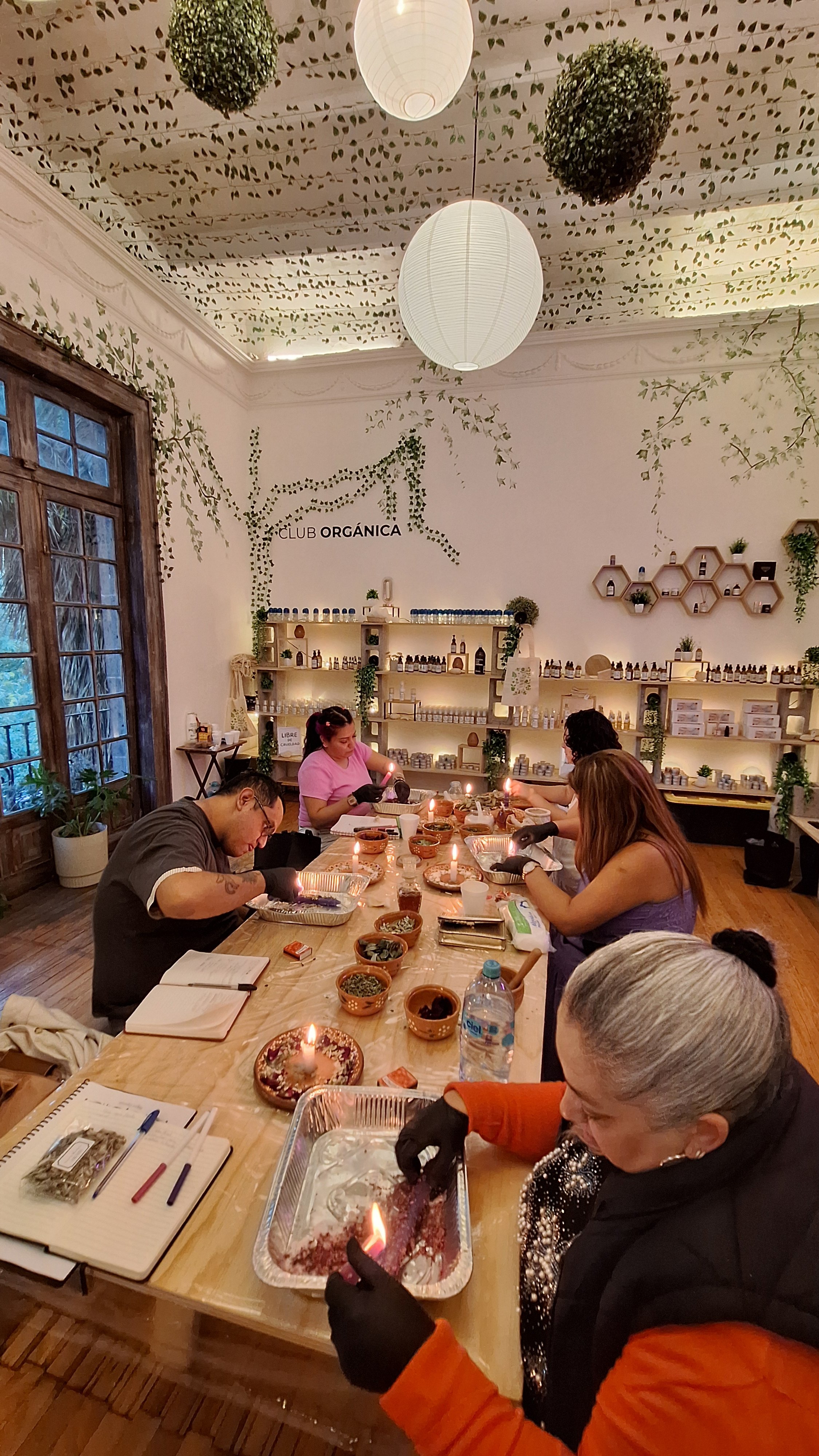 People at workshop table with candles and warm lighting